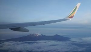 How to Get from Nairobi to Diani Beach? Plane wing and peak of Kilimanjaro in background.