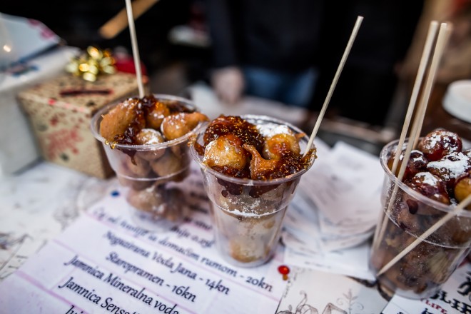 Fritule in a cup with chocolate